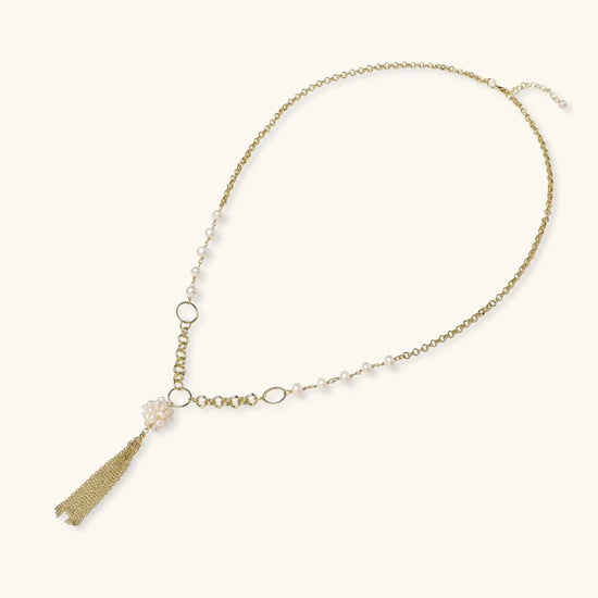 Long gold-plated necklace with freshwater pearls, chunky chain links, and flowing tassel pendant