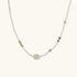 Delicate pearl necklace with pale green serpentine jade centerpiece and colorful agate beads on cream background