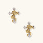 Gold-plated cross earrings with dimensional roses and crystal details on cream background, 18k gold over brass construction.