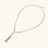 Long gold-plated necklace with freshwater pearls, chunky chain links, and flowing tassel pendant